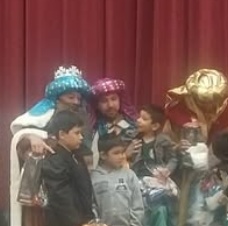 Children standing together with their arms around one another