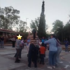 Children standing together with their arms around one another