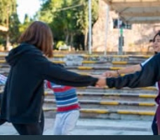 Children standing together with their arms around one another