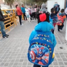 Children standing together with their arms around one another
