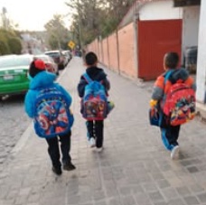 Children standing together with their arms around one another