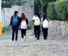 Children standing together with their arms around one another