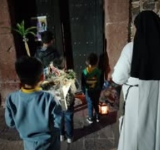 Children standing together with their arms around one another