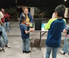 Children standing together with their arms around one another